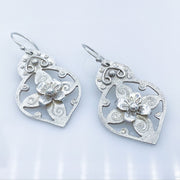Pierced Floral Arabesque Sterling Silver Earrings laying diagonal