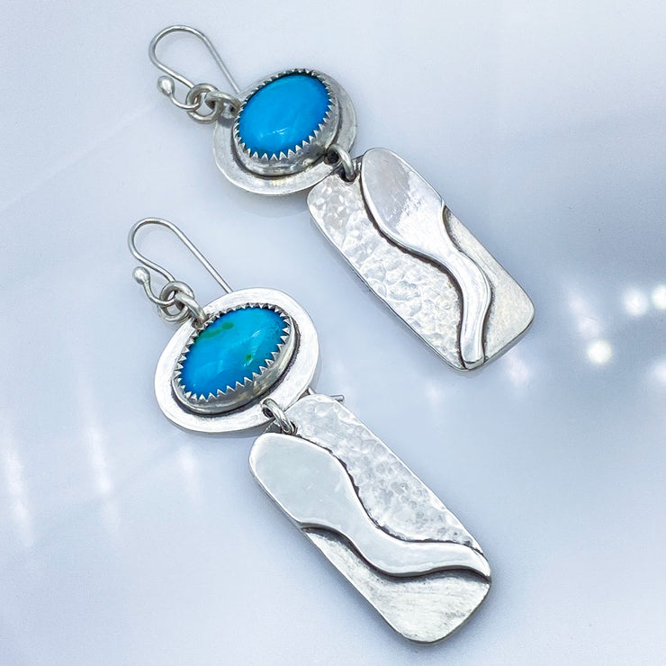 Turquoise and Sterling Silver River Earrings Size Comparison laying diagonal