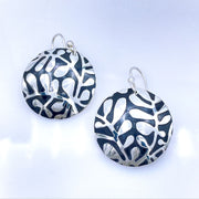 Sterling Silver Modern Vine Textured Domed Medallion Earrings laying flat