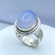 Oval Blue Chalcedony Brushed Sterling Silver Ring on Finger Three Quarter View
