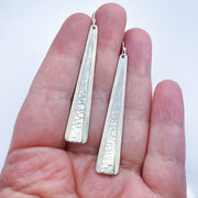 Sterling Silver Double Triangle Earrings size comparison to hand