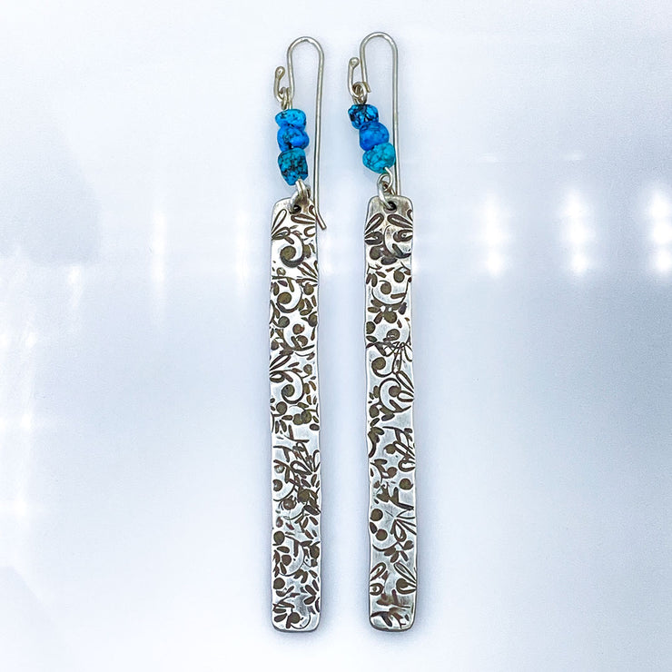 Sterling Silver Floral Bar Earrings with Turquoise Beads laying flat
