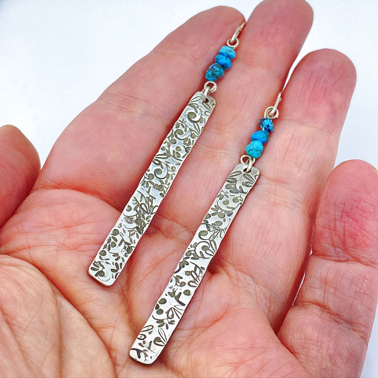 Sterling Silver Floral Bar Earrings with Turquoise Beads size comparison to hand