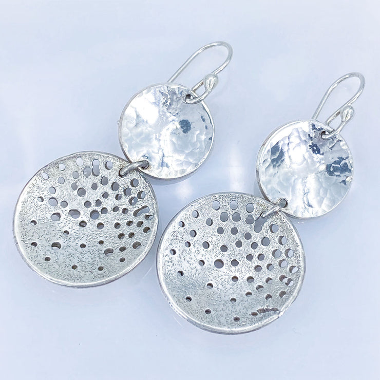 Sterling Silver Hammered and Distressed Disc Earrings laying diagonal