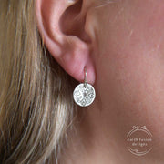Sterling Silver Radiant Petal Stamped Disc Earrings on Model