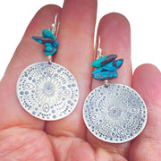 Turquoise Beaded Sterling Silver Stamped Medallion Earrings in comparison to a hand
