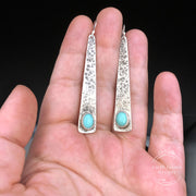 Turquoise Sterling Silver Triangle Earrings in comparison to a hand
